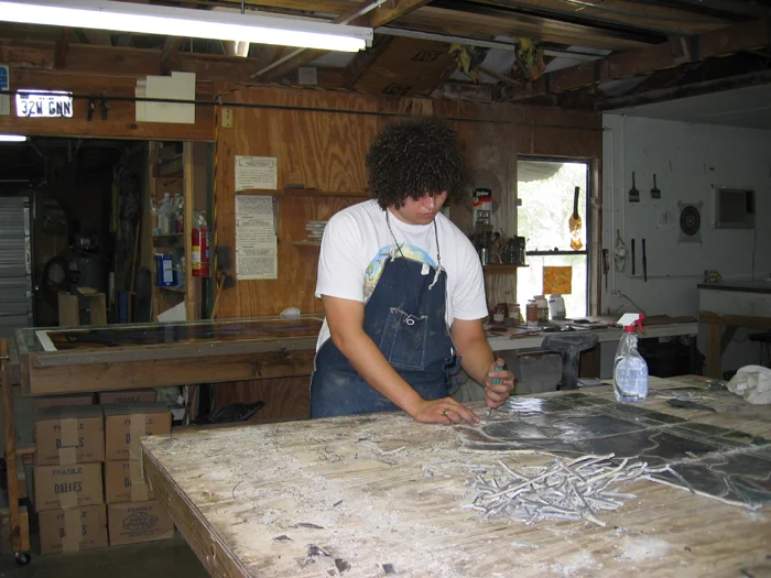 STEP 2 Carlos has began disassembling the window, piece by piece. The surrounding lead is cut, the piece carefully removed and then cleaned.