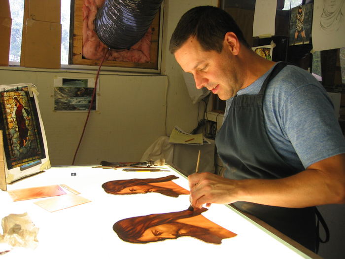 STEP 4 Scott puts the final touches on one of the new faces. He painted several with different paints and different layers to determine the best way to replicate the style the original painters used. Each piece will go through several firings in the kiln and several layers of paint before it is complete.