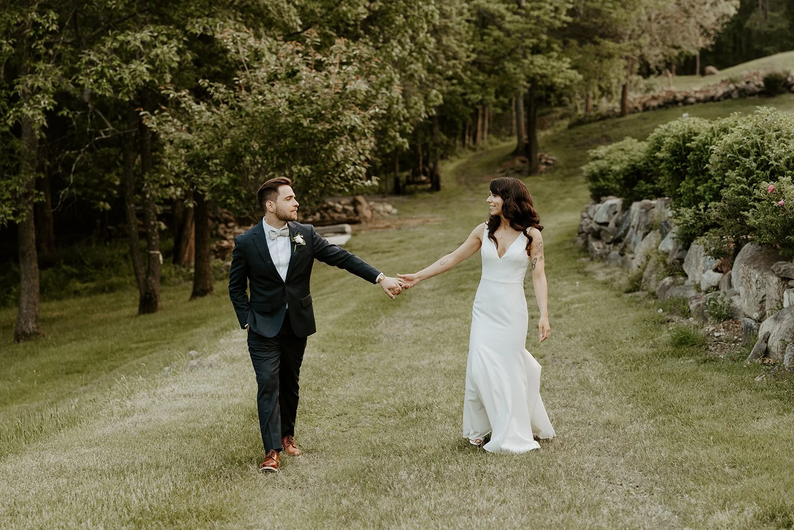A bride and groom walking hand in hand through their wedding venue