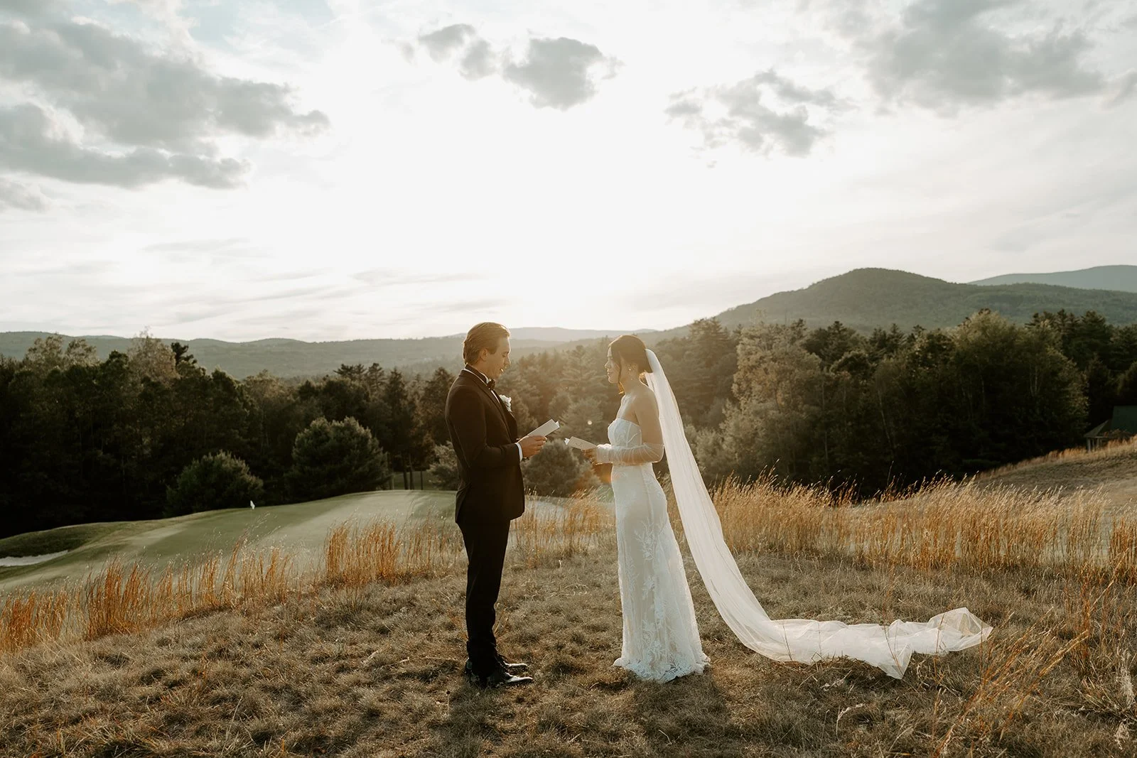 A bride and groom doing vows at sunset