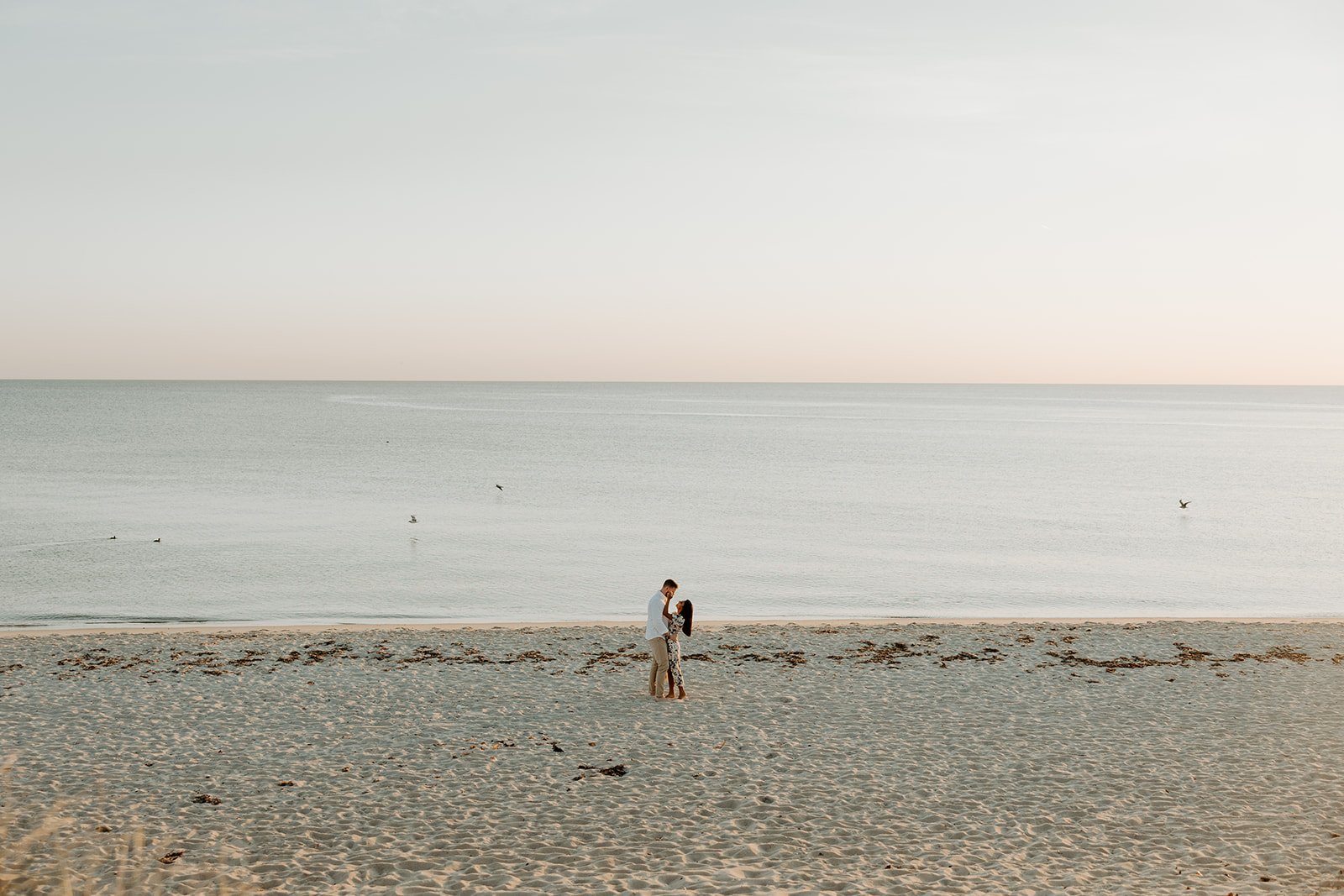 A couple showing what to wear for engagement photos on the beach