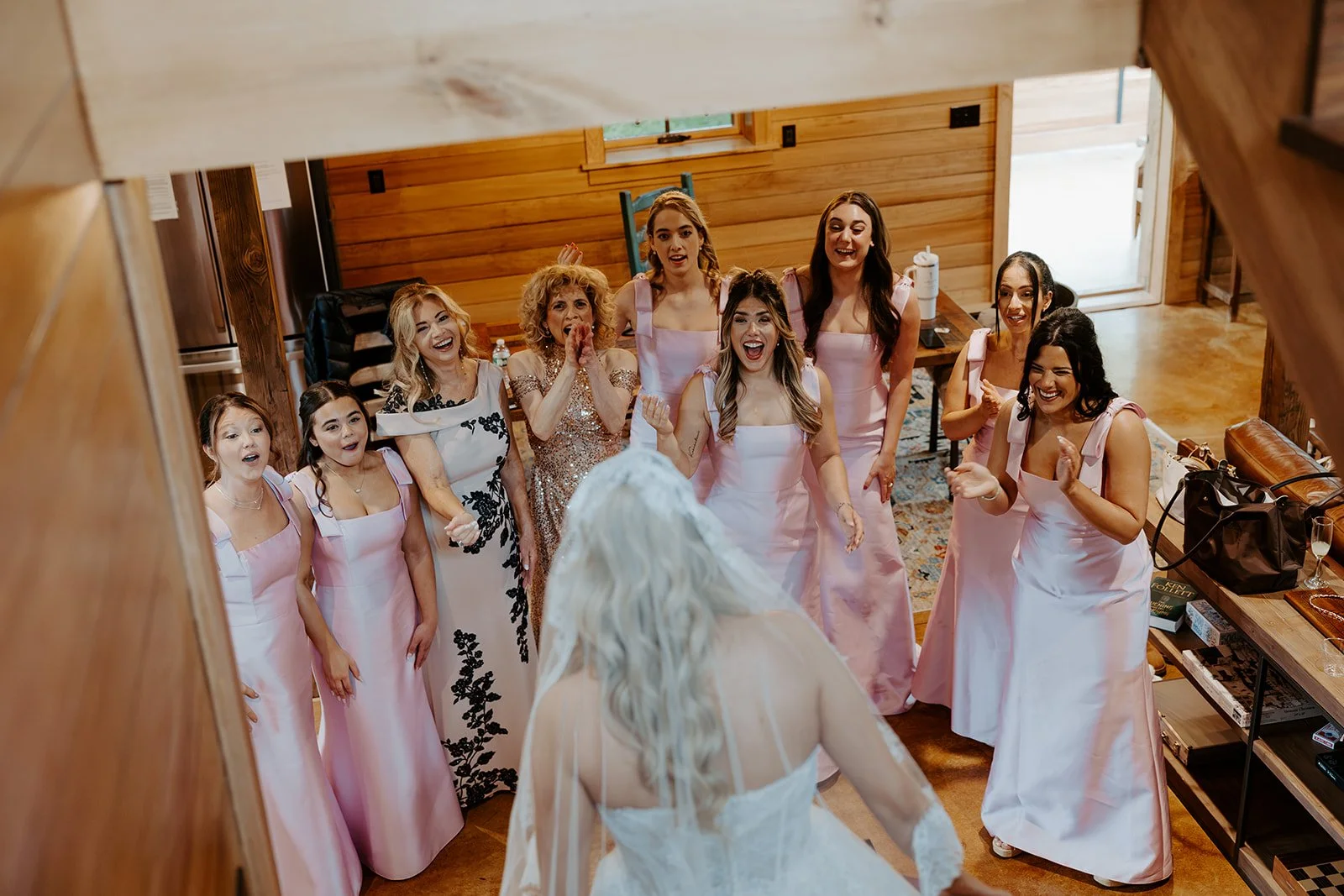 Bridesmaids reacting to a bride