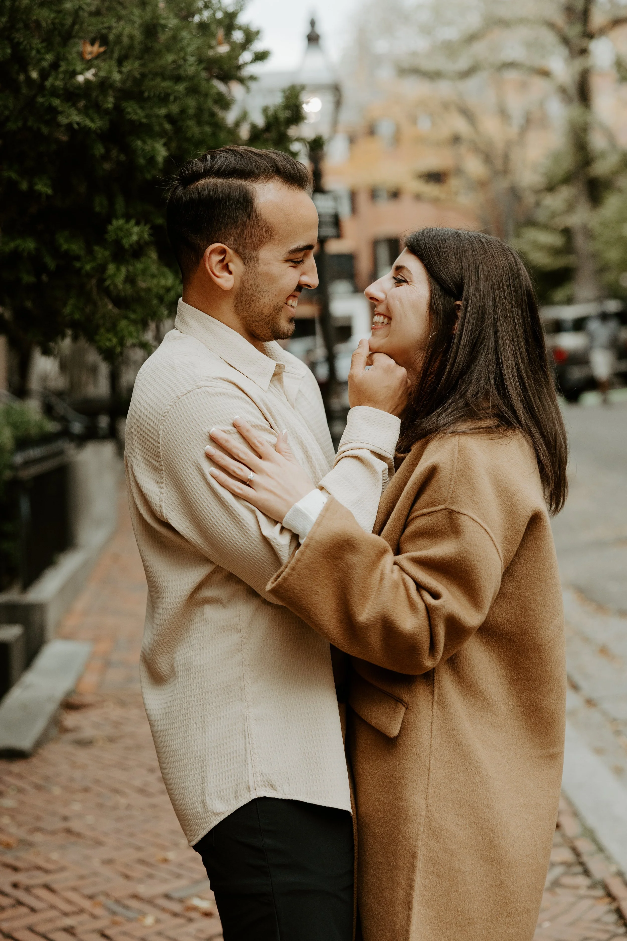 A couple posing for their engagement photoshoot in Boston