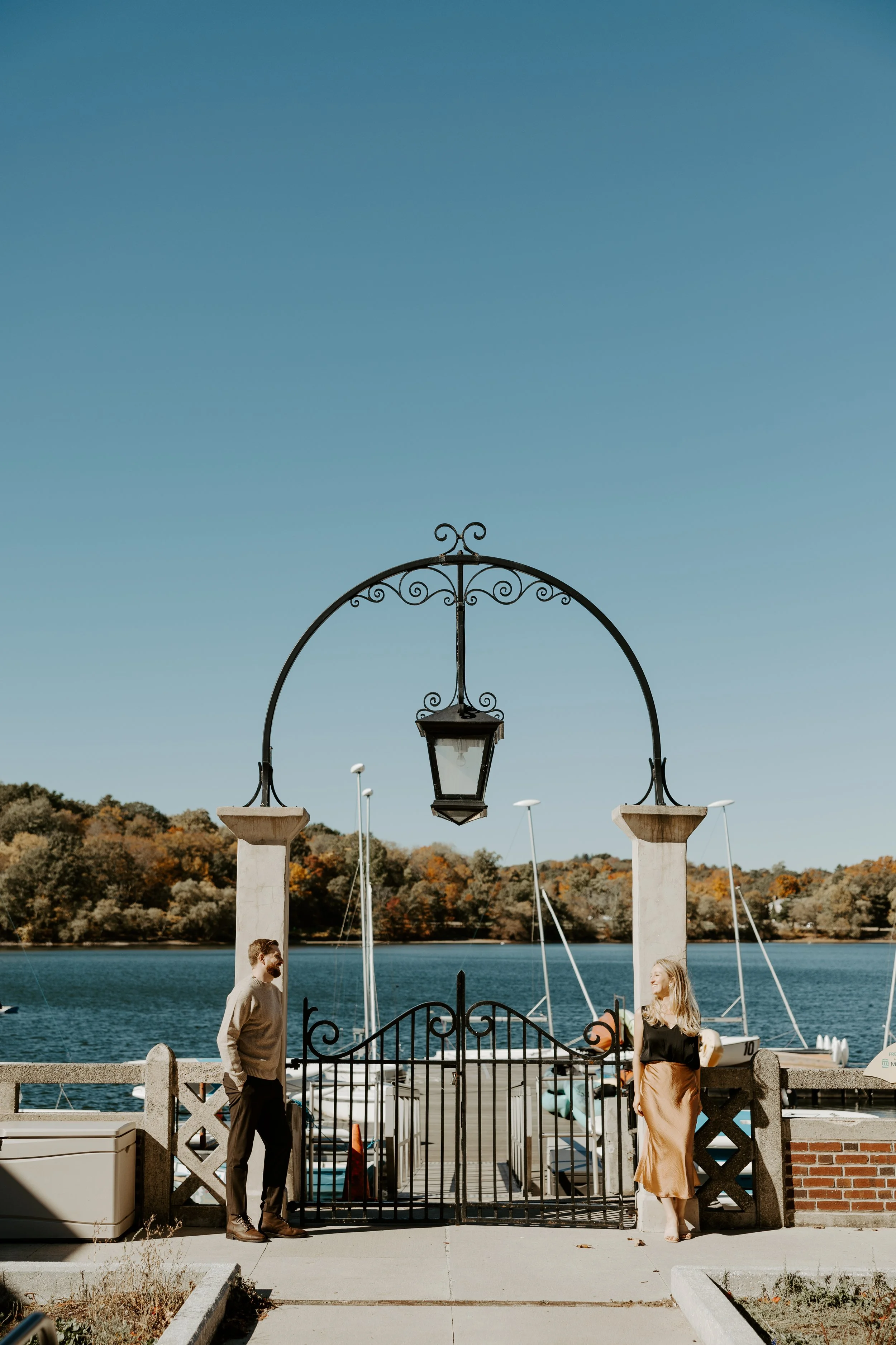 A couple posing for coastal engagement photos in Boston