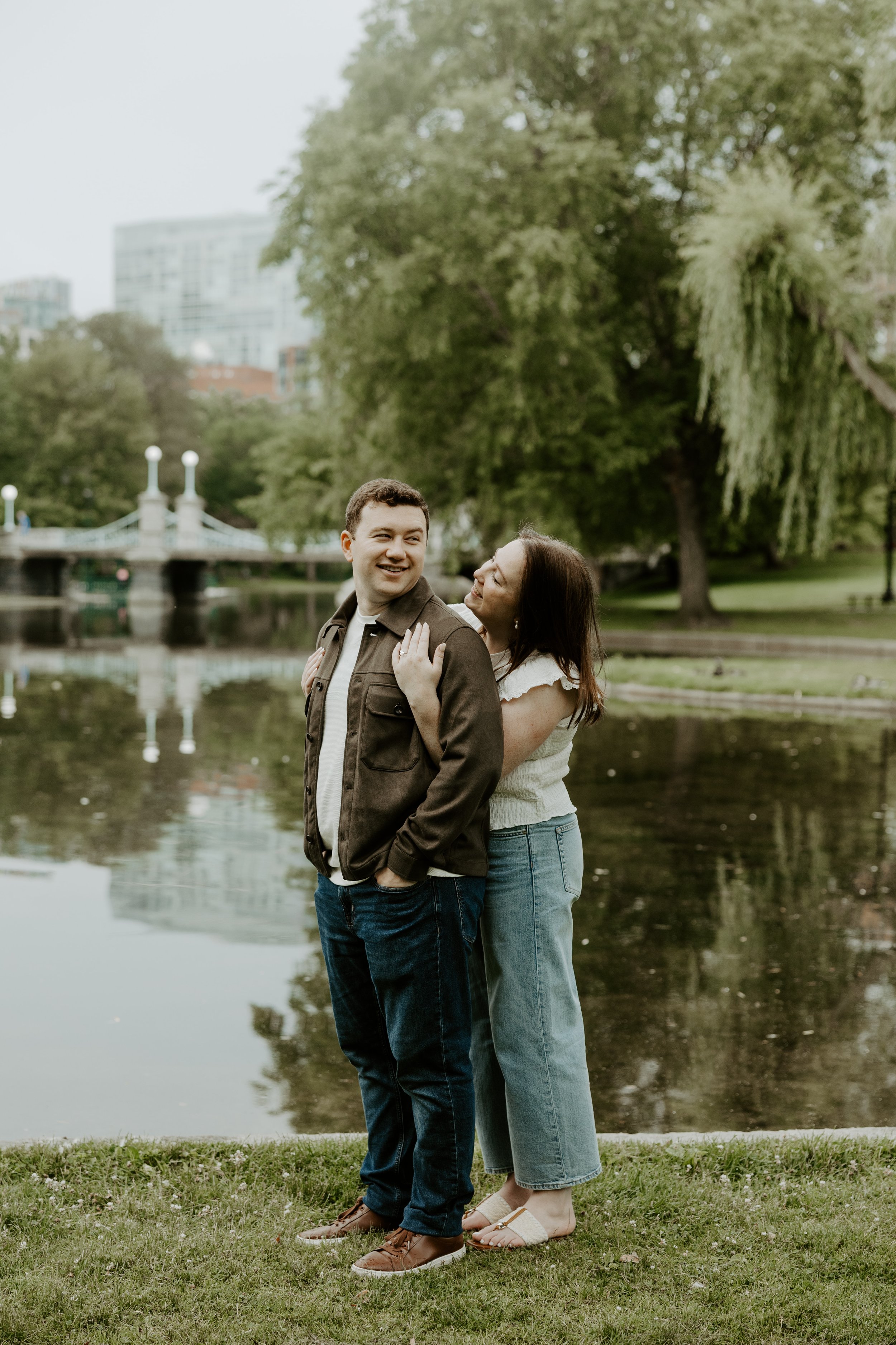 A couple posing for engagement photos at the Esplanade in Boston
