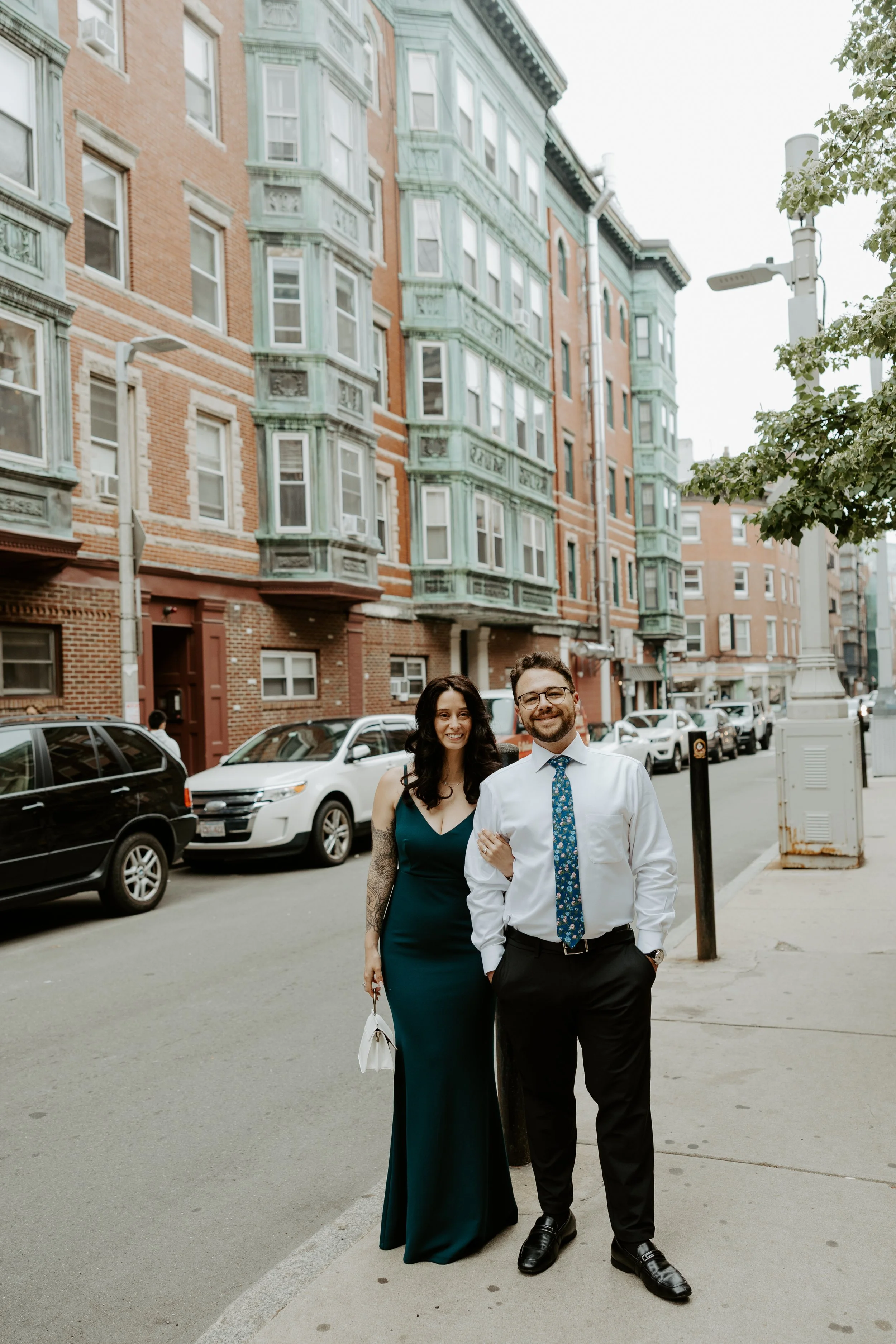 A couple posing on the streets of north End, captured by a Boston engagement photographer
