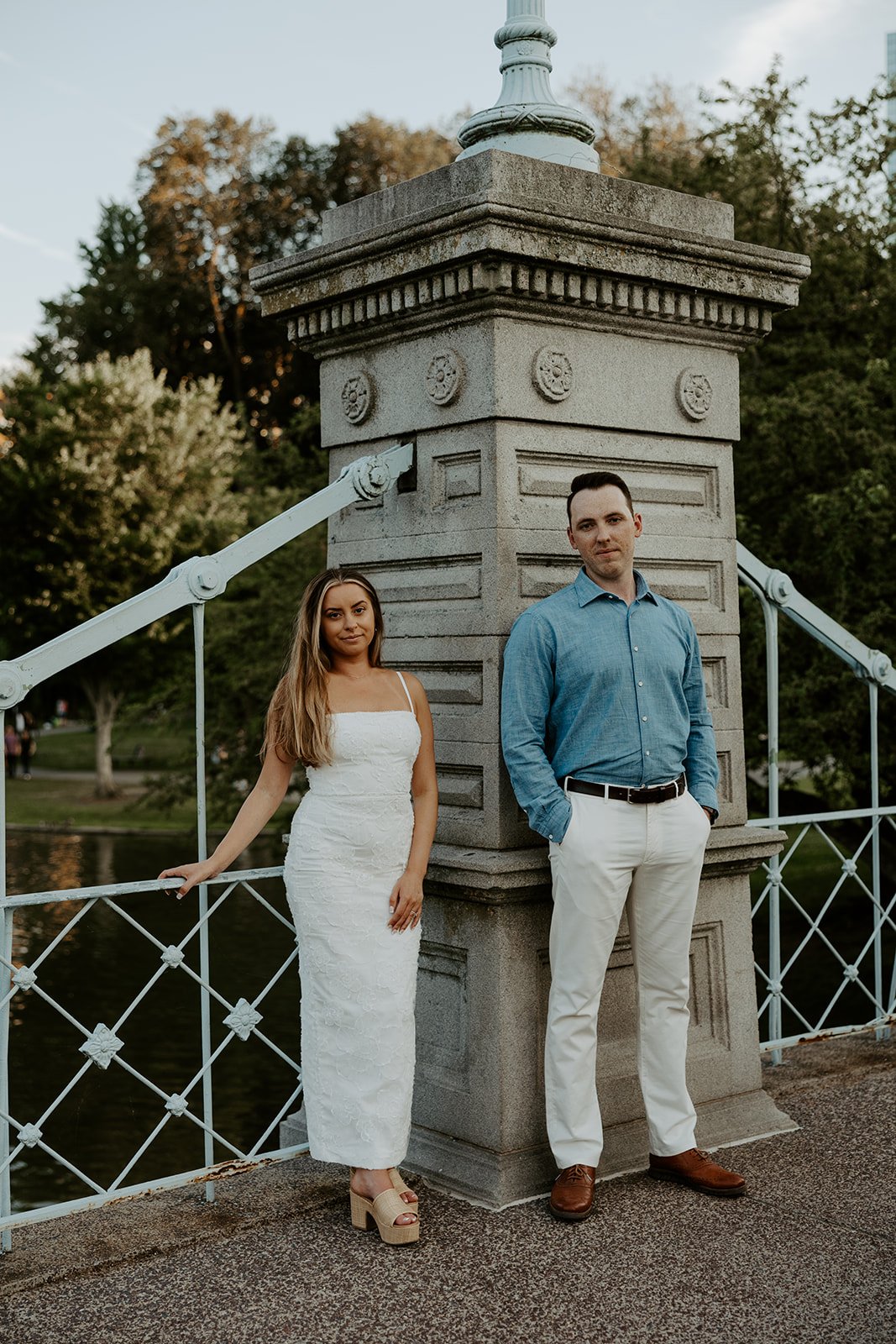 A couple posed by a Boston engagement photographer during their engagement photoshoot at Public Garden