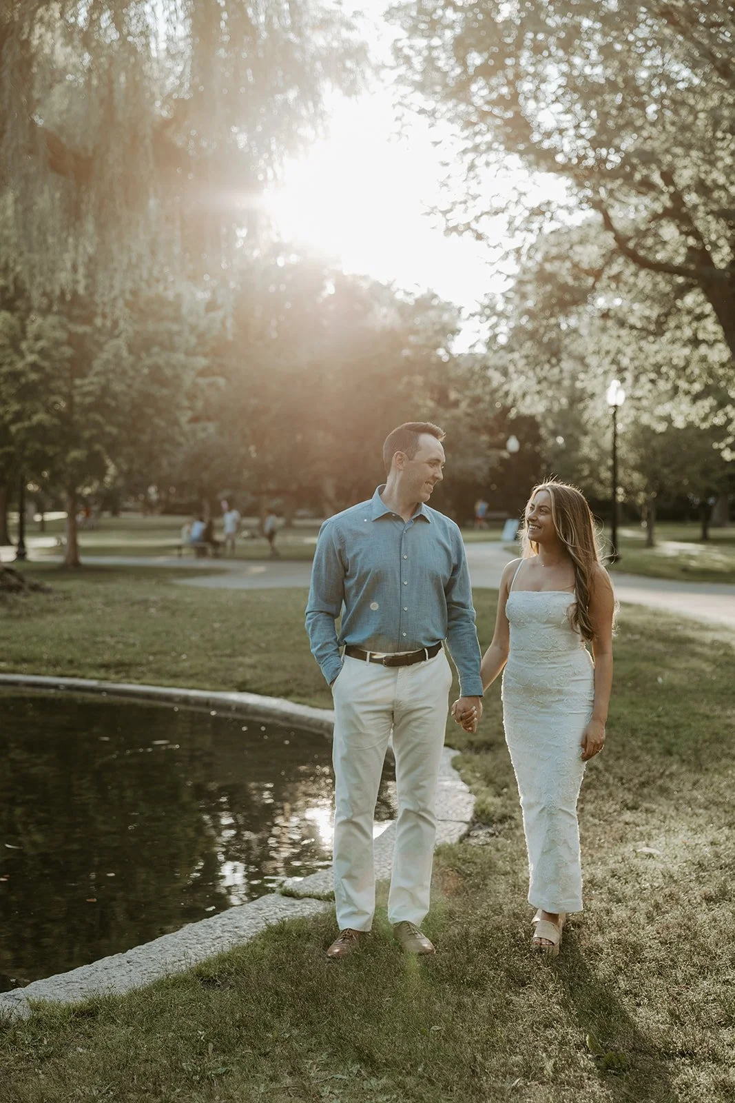 A couple walking through public garden for their engagement photoshoot