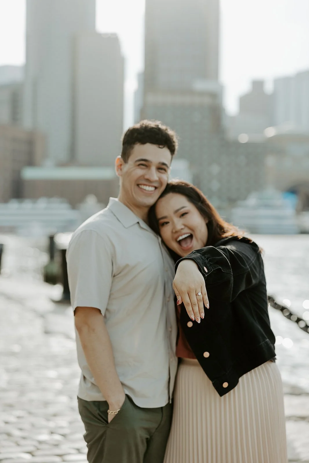 A girl showing off her engagement ring to a Boston engagement photographer