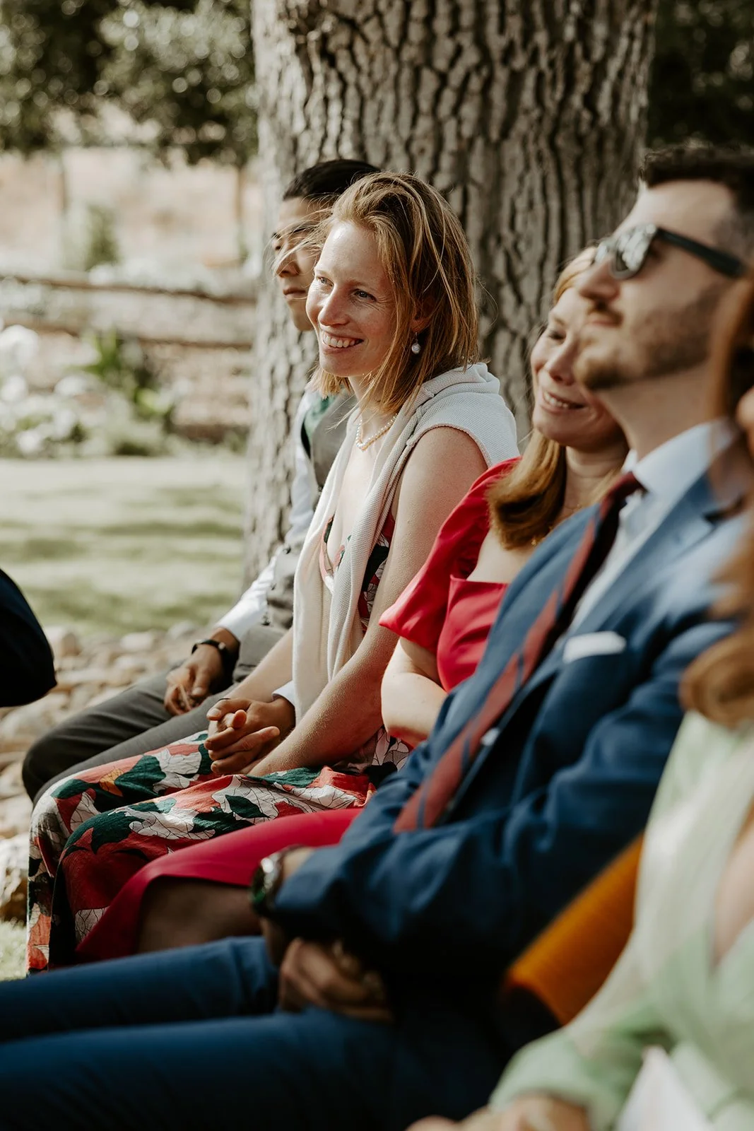 Documentary style wedding photography of guests watching a wedding ceremony