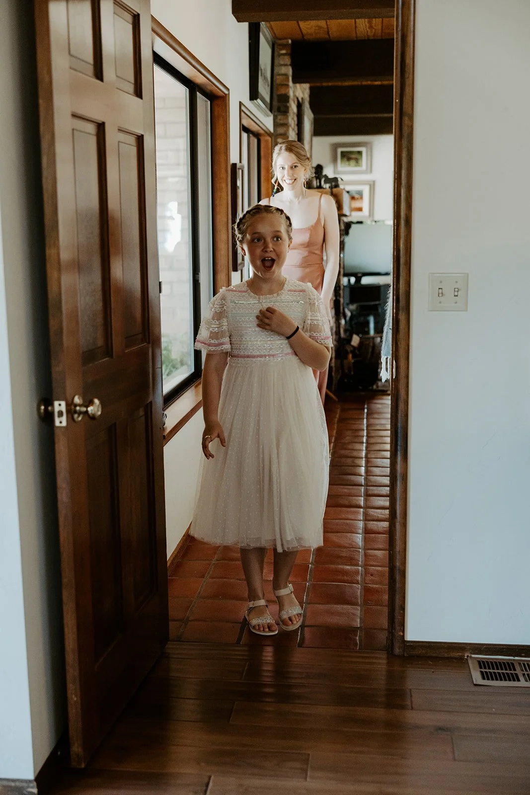 The flower girl's reaction to a bride in her wedding dress