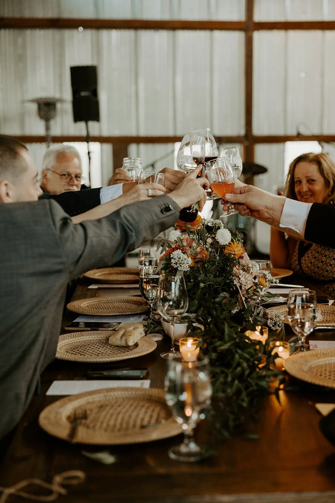 Wedding guests clinking cups at a whimsical wedding reception