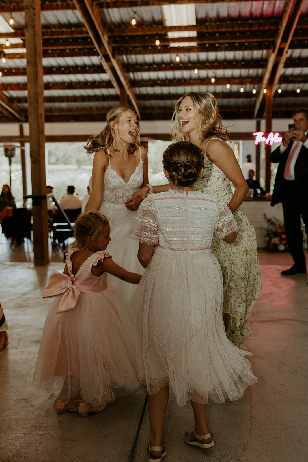 A bride dancing with wedding guests captured through documentary style wedding photography