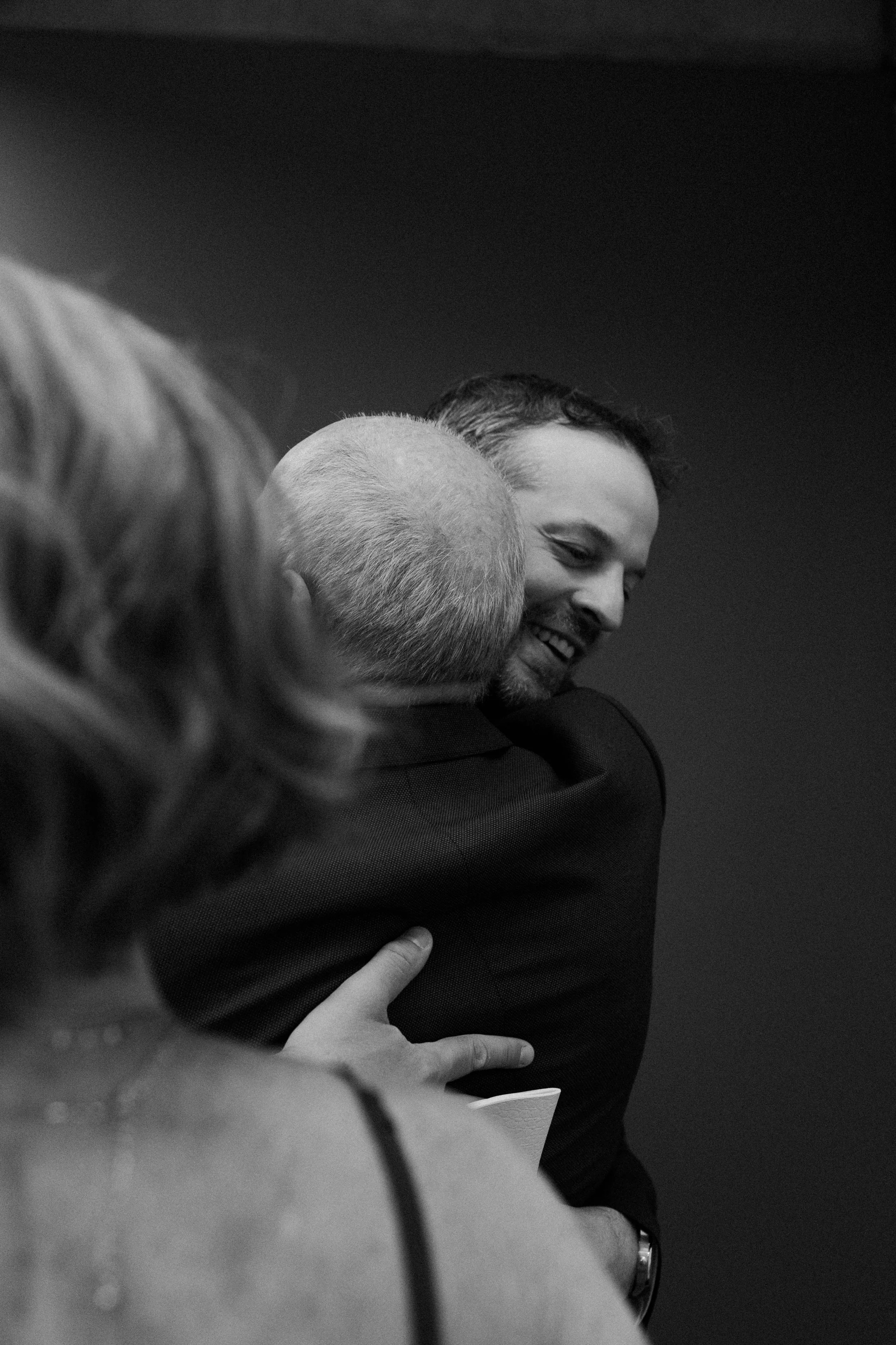 A man hugging his dad after his Boston elopement at Boston city hall