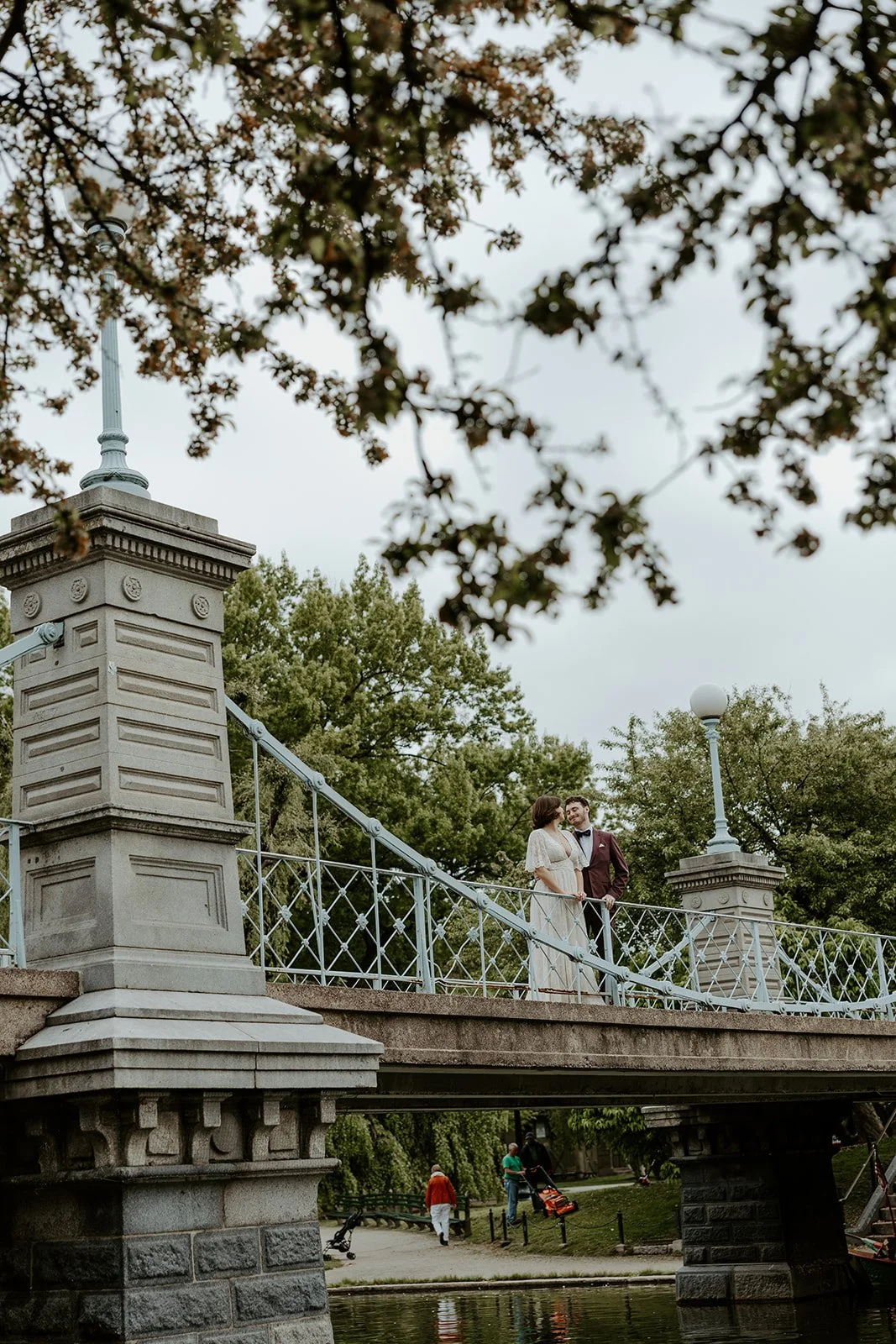 A couple standing on a bridge at their elopement location, the Esplanade
