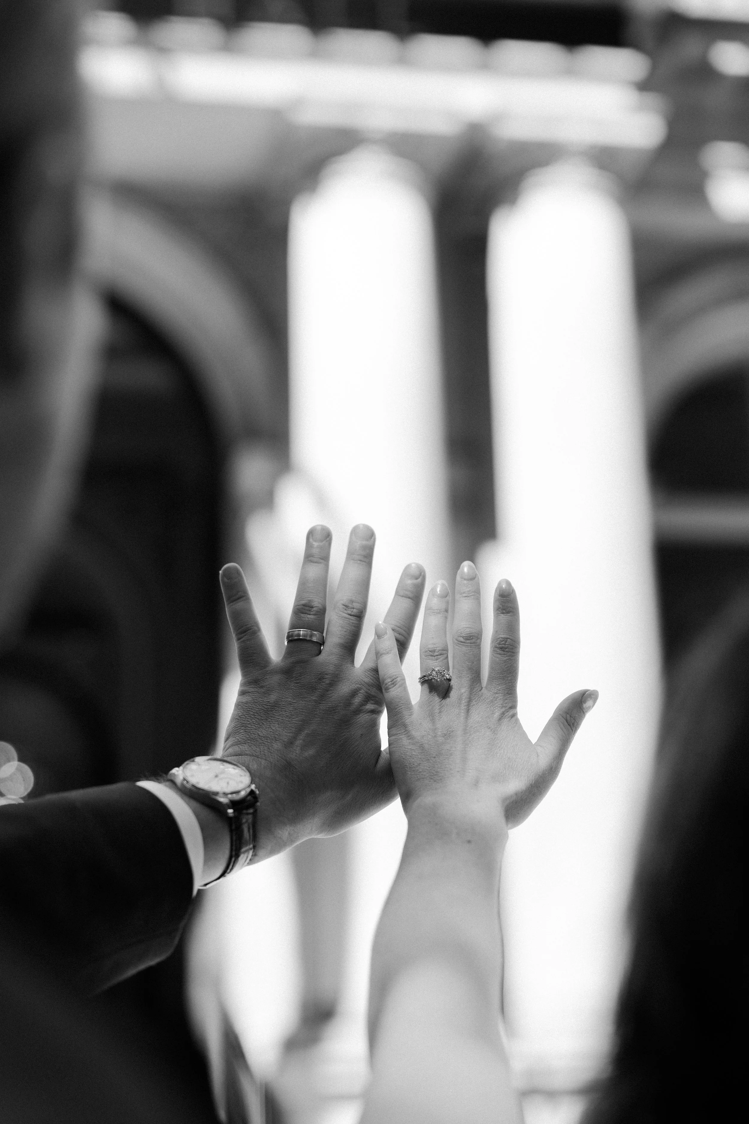 A couple showing off their wedding rings after their city hall wedding