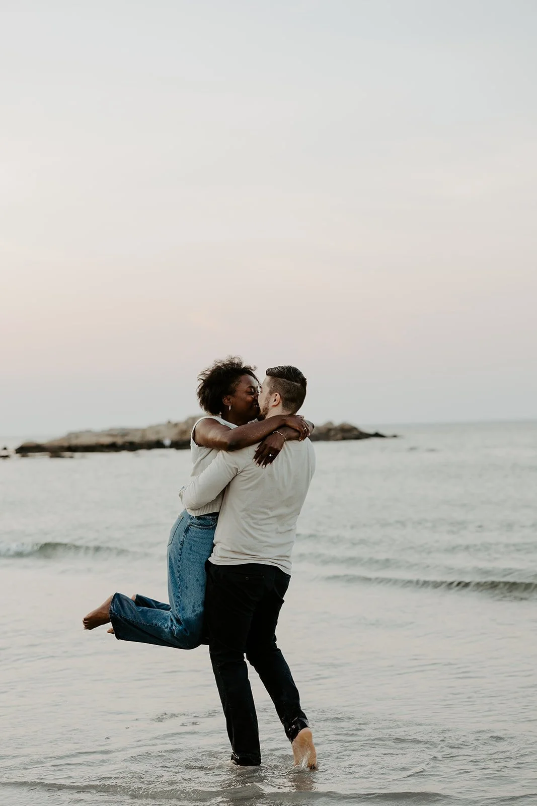 A man picking up his fiancee on the beach