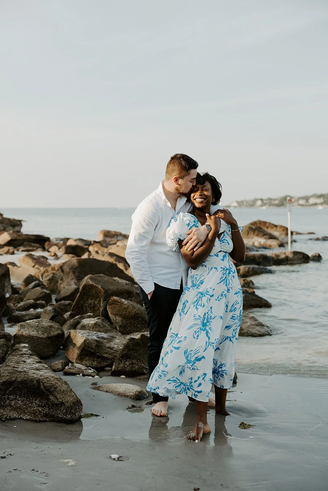 A couple posing for photos on Wingaersheek beach