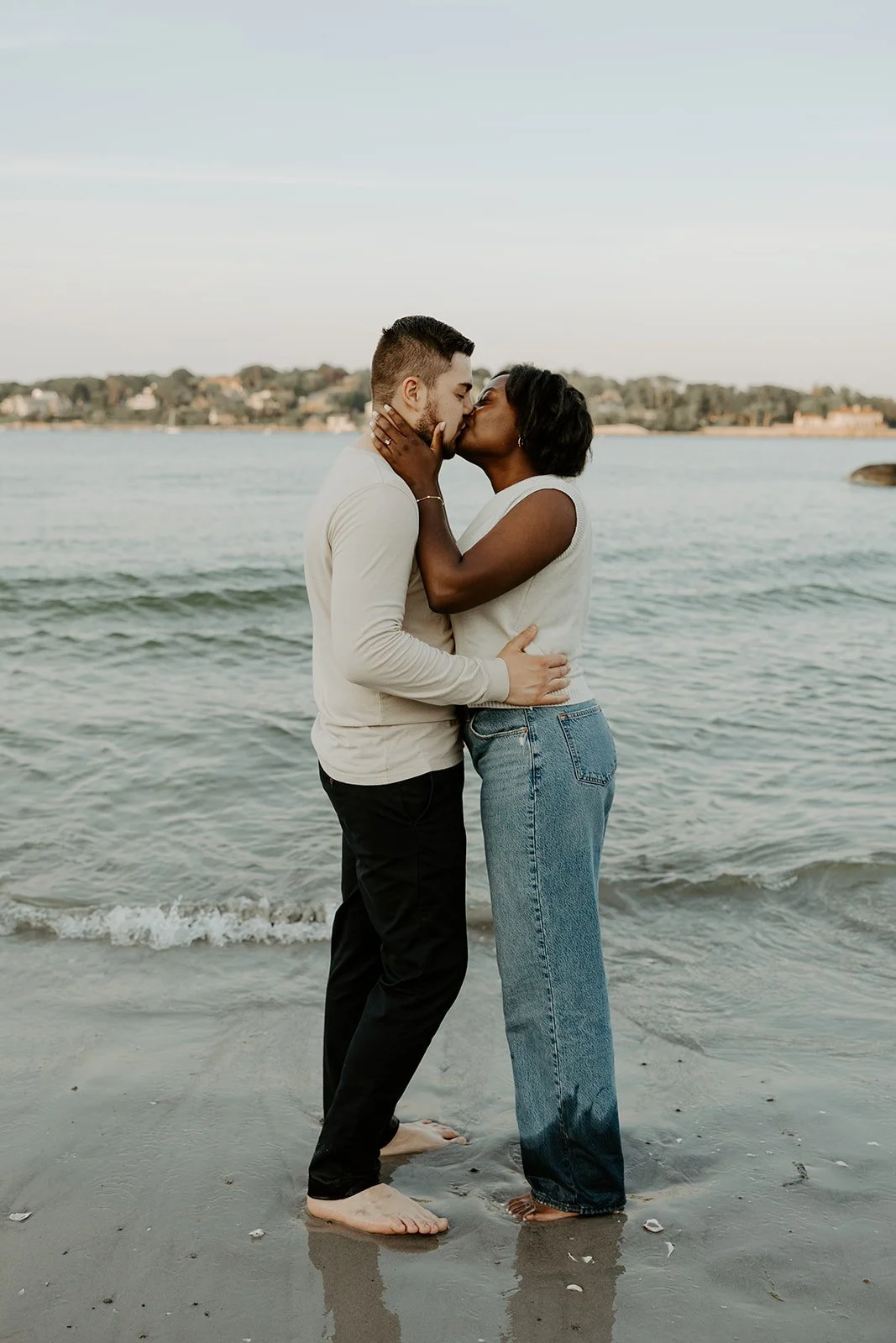 A couple kissing on the beach during their beach engagement photoshoot