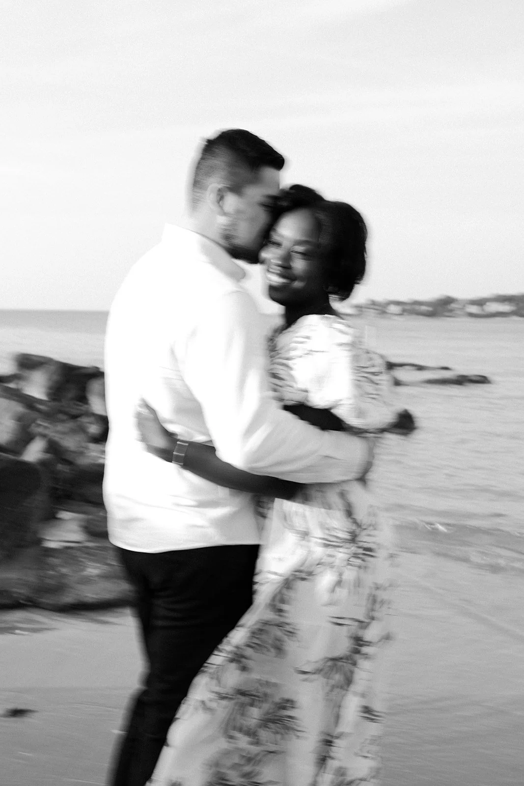 A blurry photo of a couple on the beach for beach engagement photos