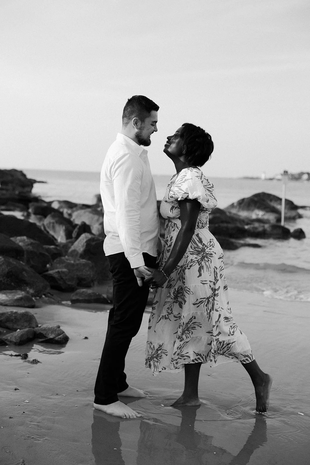 A couple leaning in for a kiss during their beach engagement photos