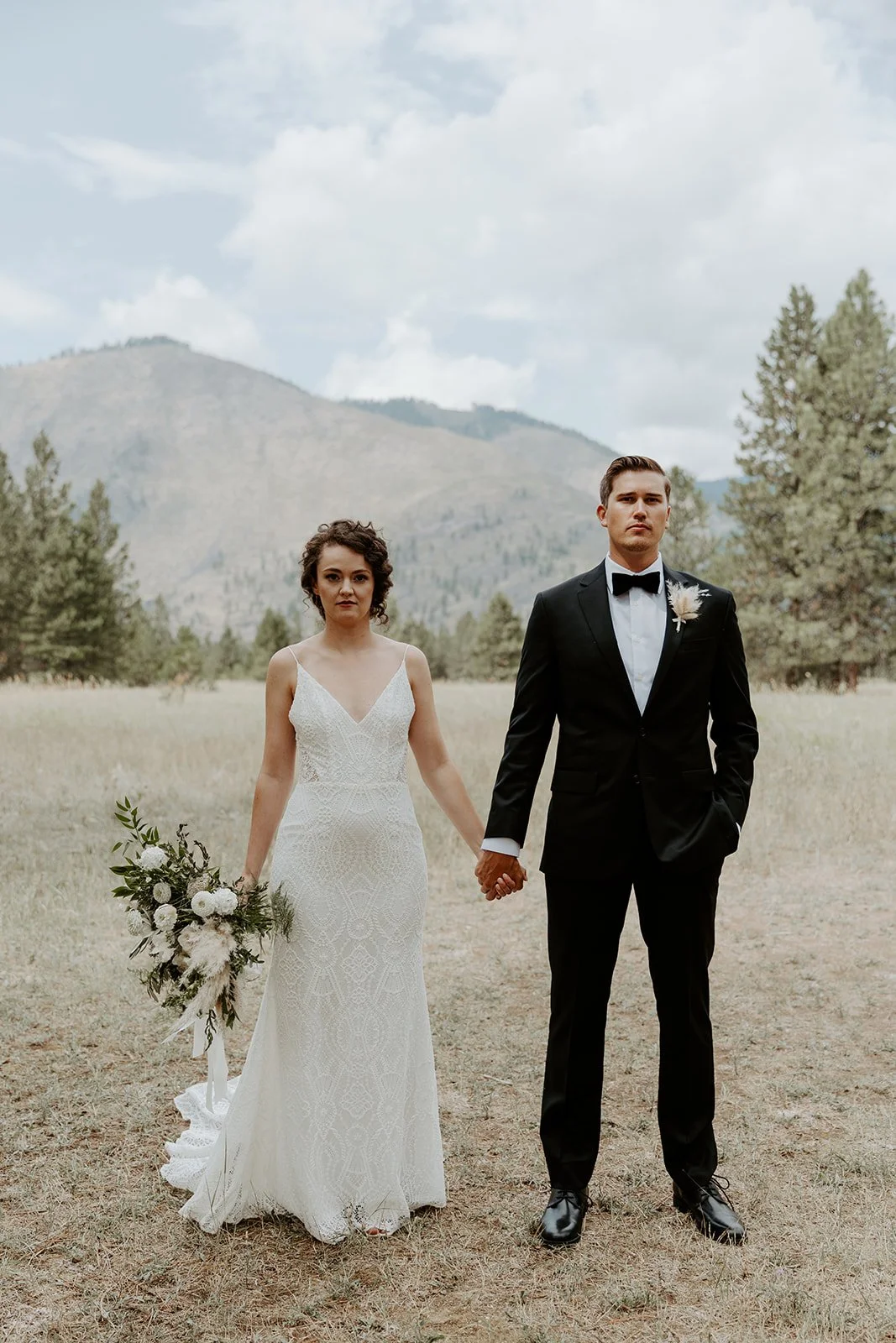 A couple posing for wedding photos at their destination wedding location in Montana