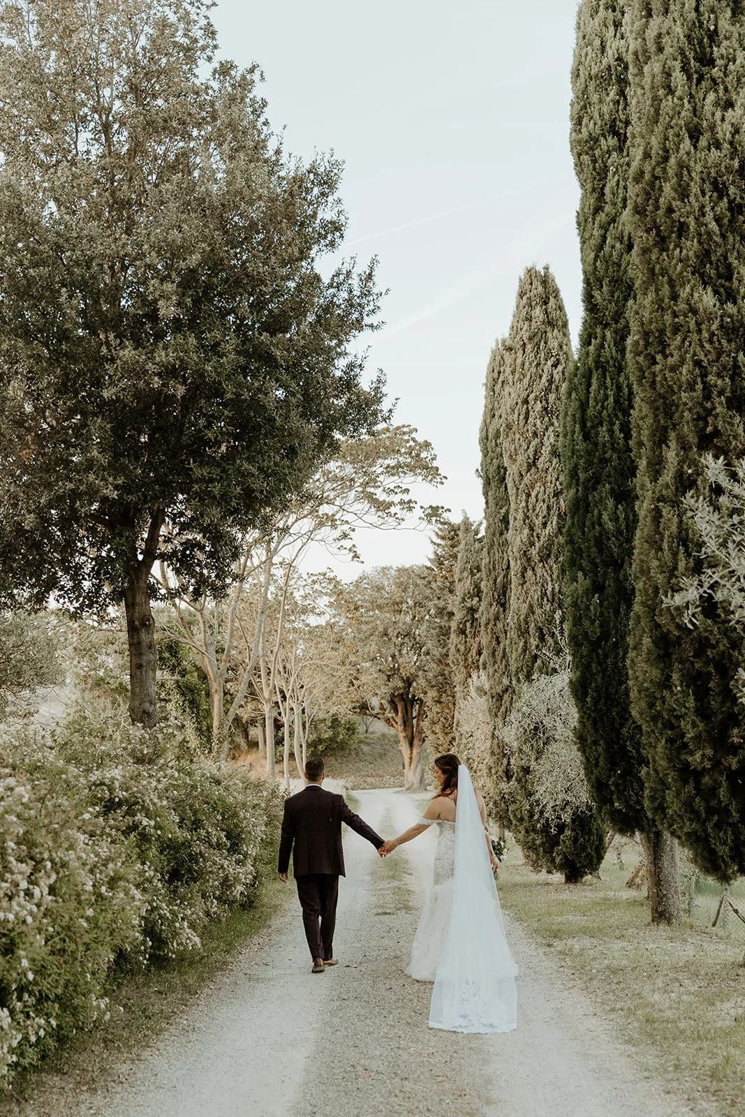 A couple walking hand in hand down a street in Italy