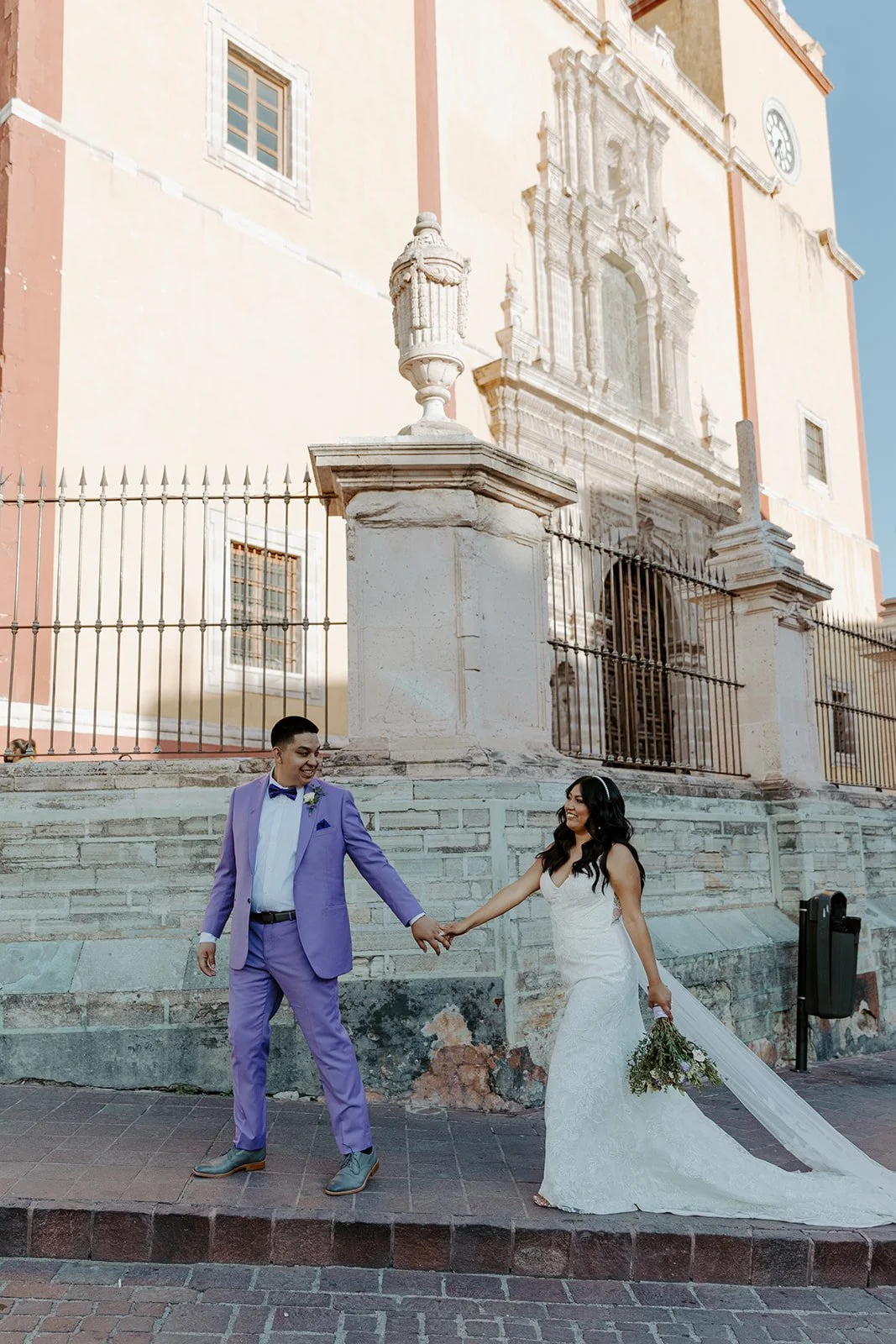 A couple walking holding hands at their destination wedding location in MExico