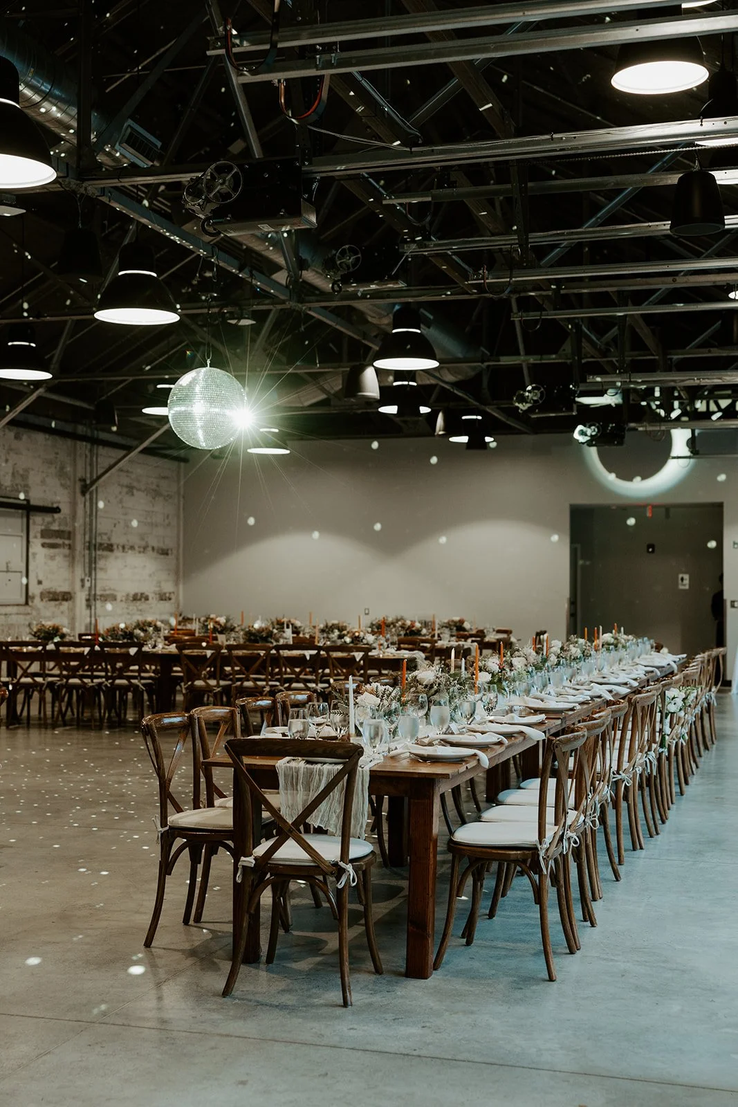 The inside of an industrial wedding venue, garage b, set up for a wedding reception