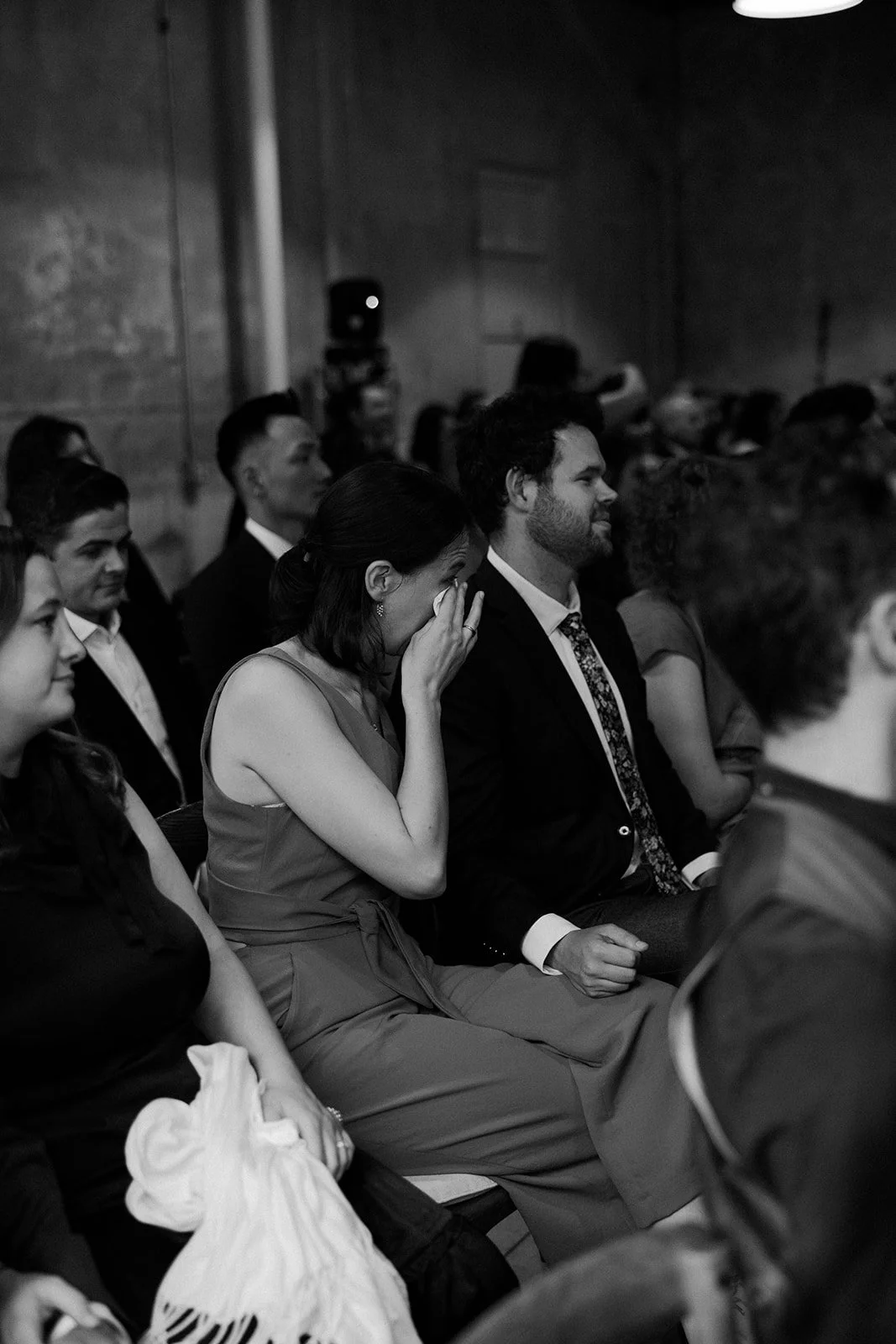 A wedding guest crying during a wedding reception