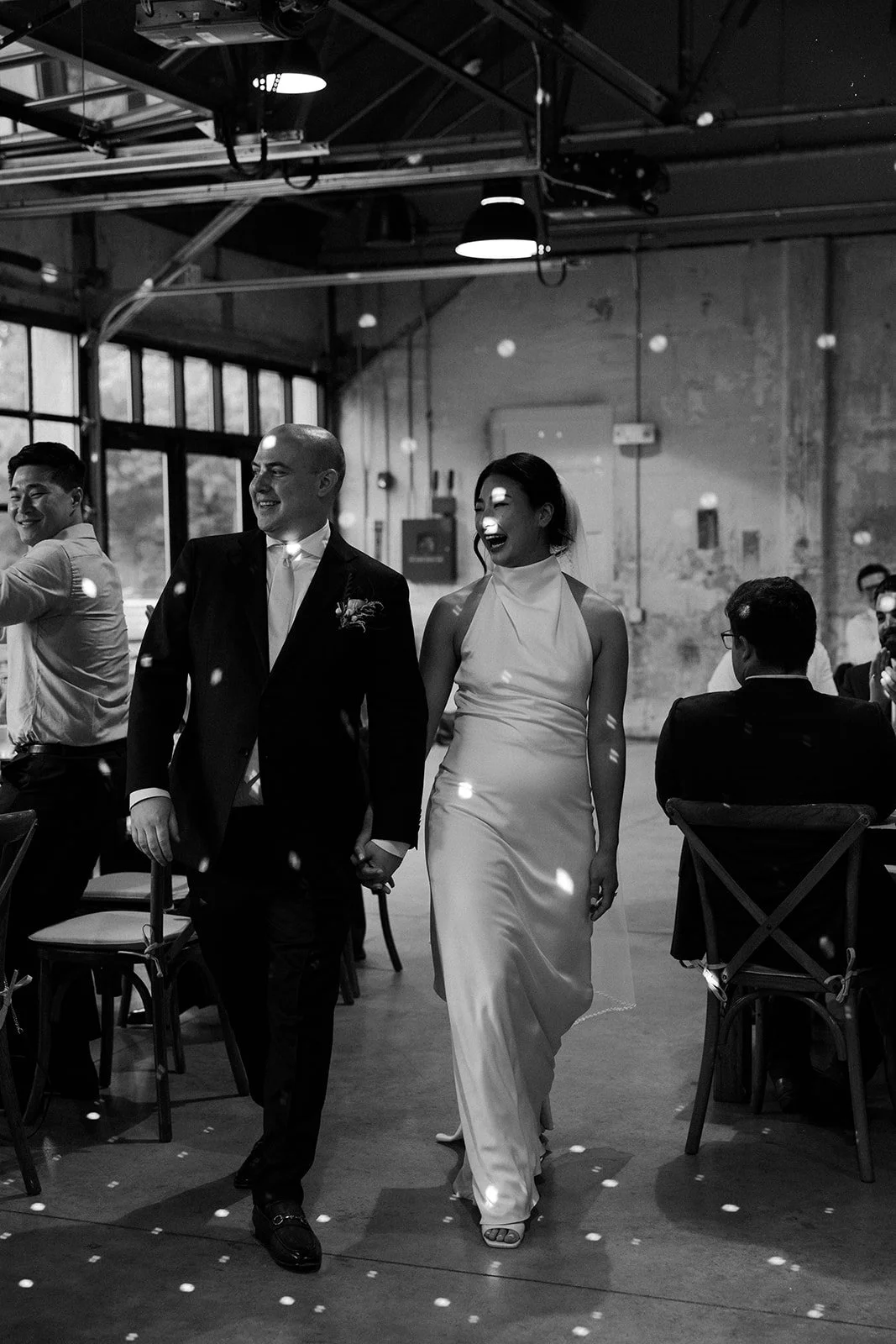 A bride and groom entering their wedding reception at Garage B