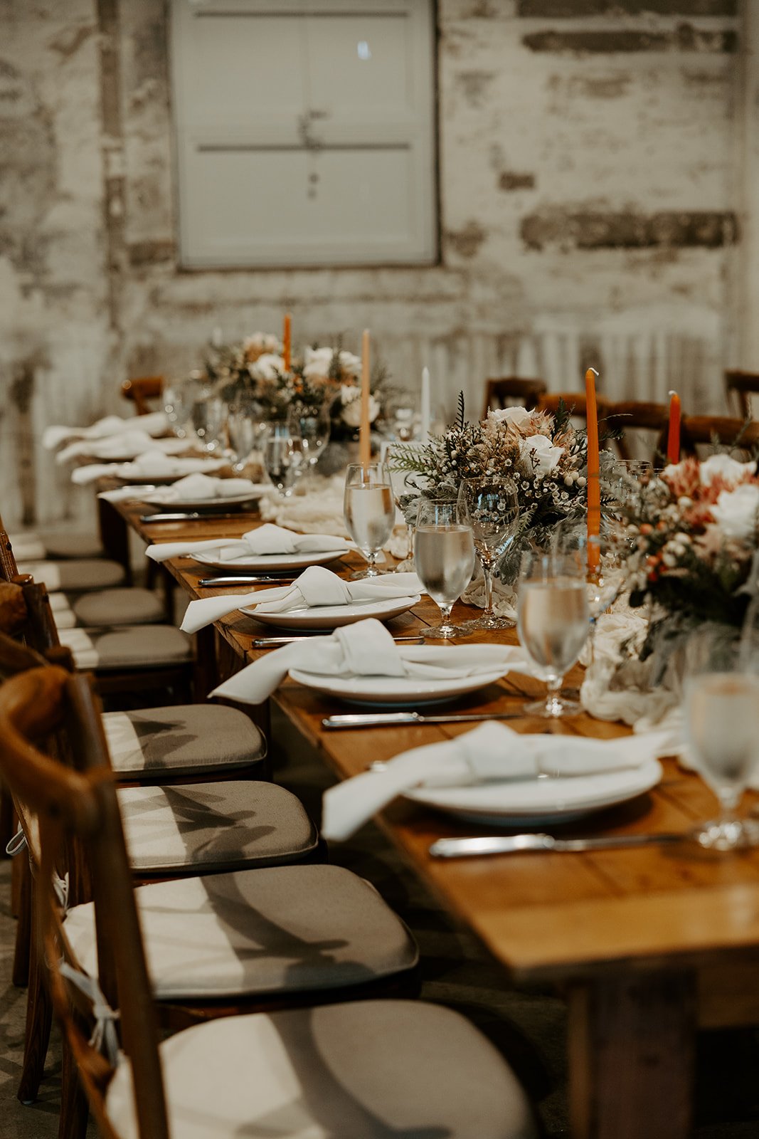 A wedding reception table setup at garage b