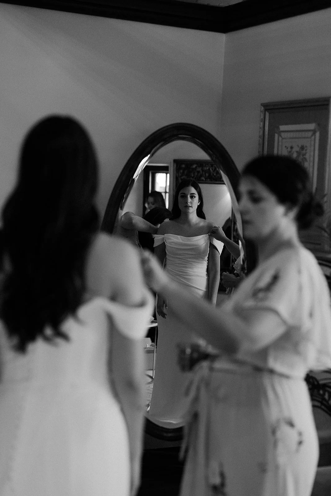 A woman getting ready for her wedding with the help of her mom
