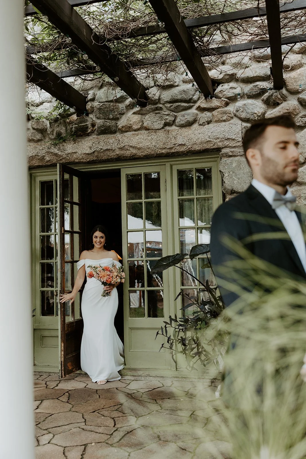 A woman walking out towards her groom for a wedding first look