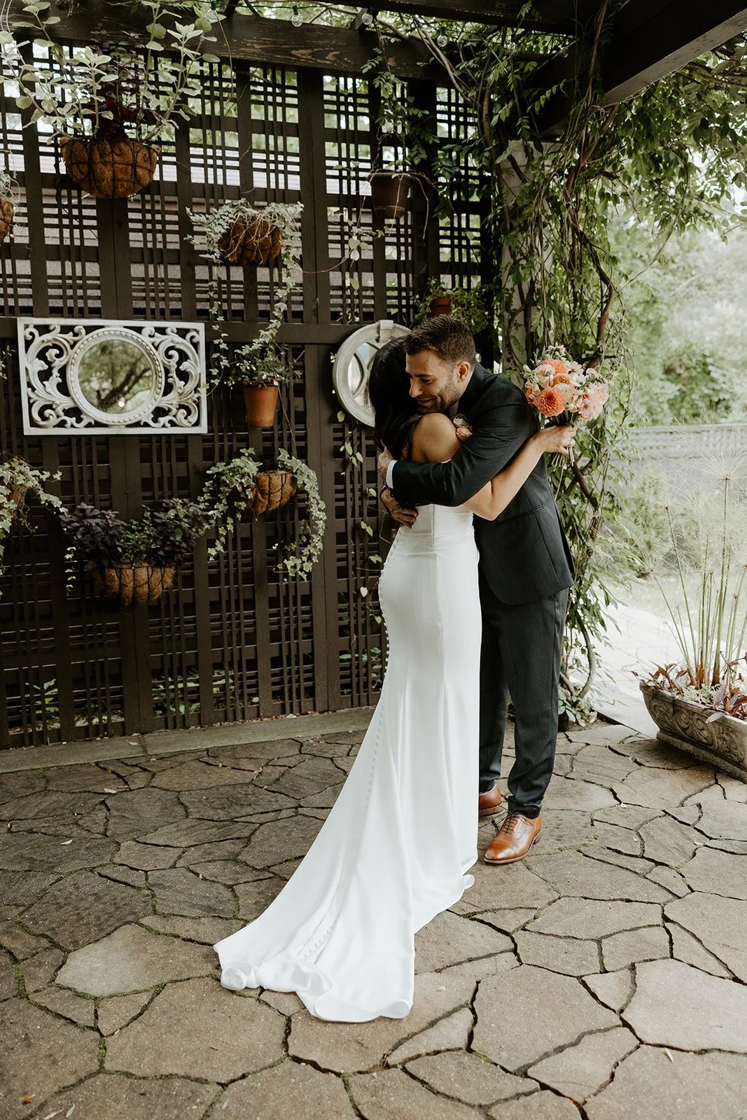 A bride and groom hugging after a wedding first look