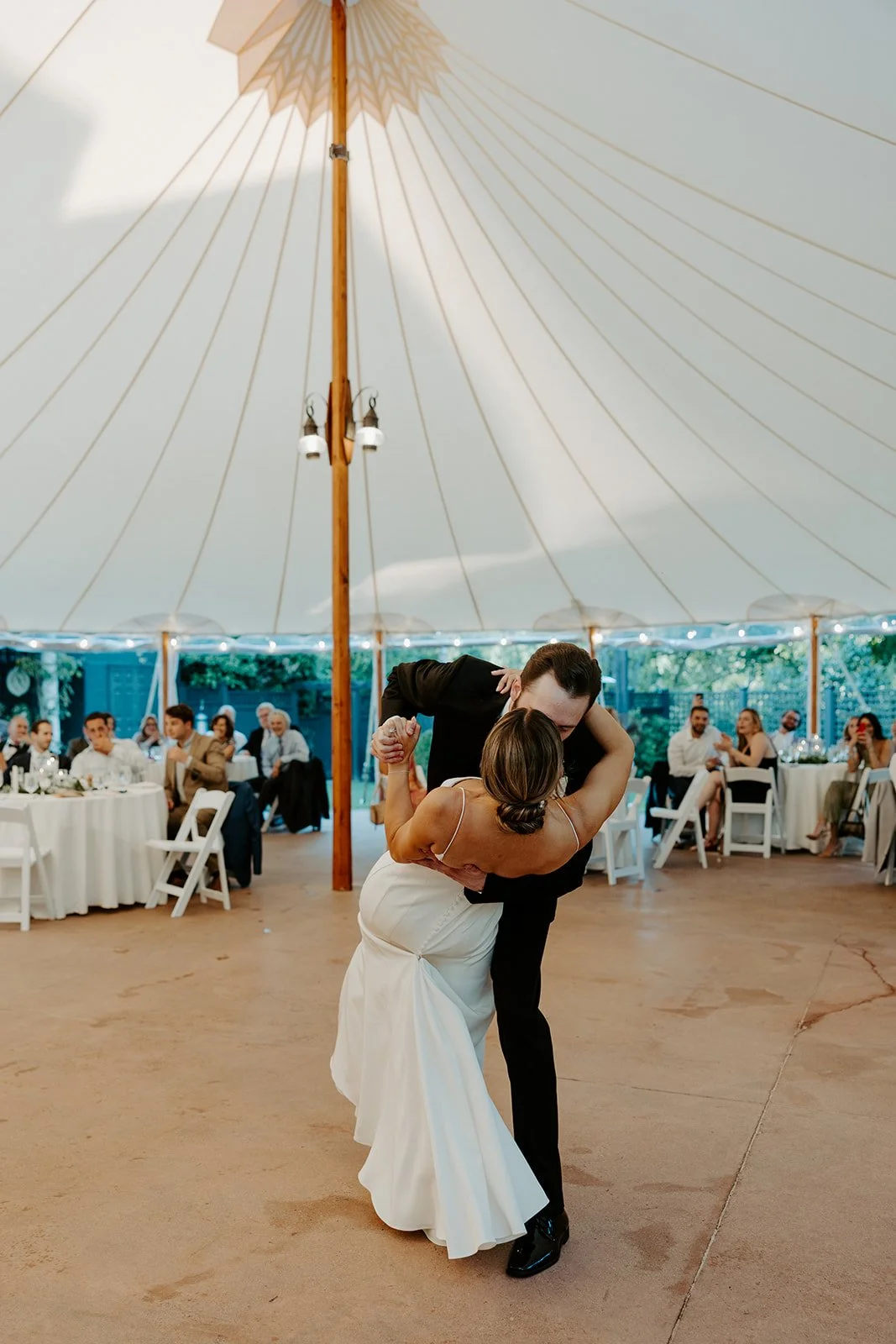 A birde and groom shairng their first dance at their wedding reception