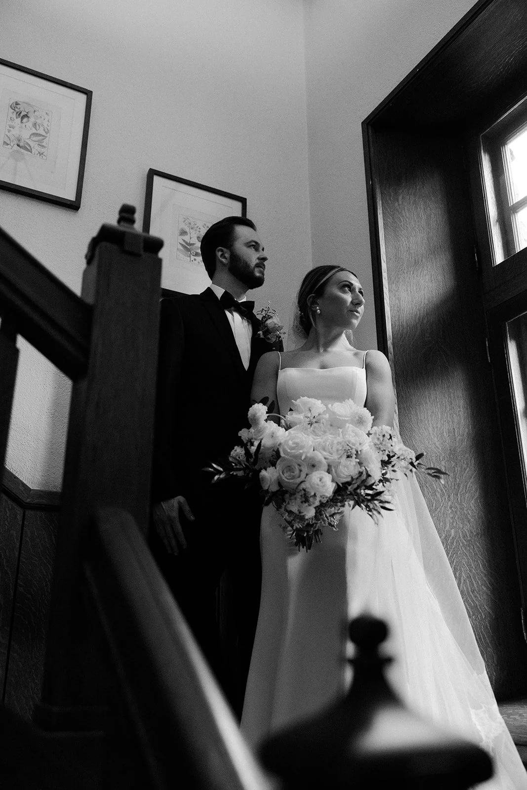 A bride and groom taking photos inside of a mansion wedding venue