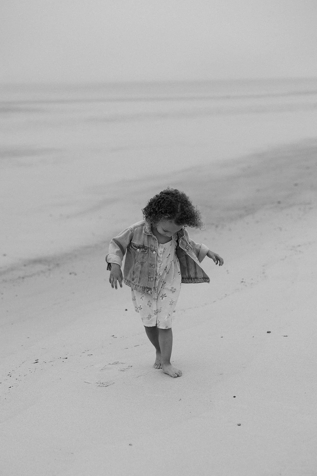 A little girl walking on the beach