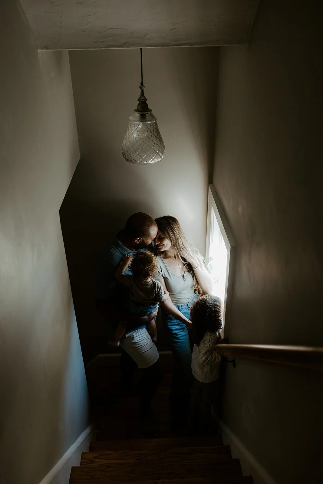 A family sitting on their steps for family photos at home