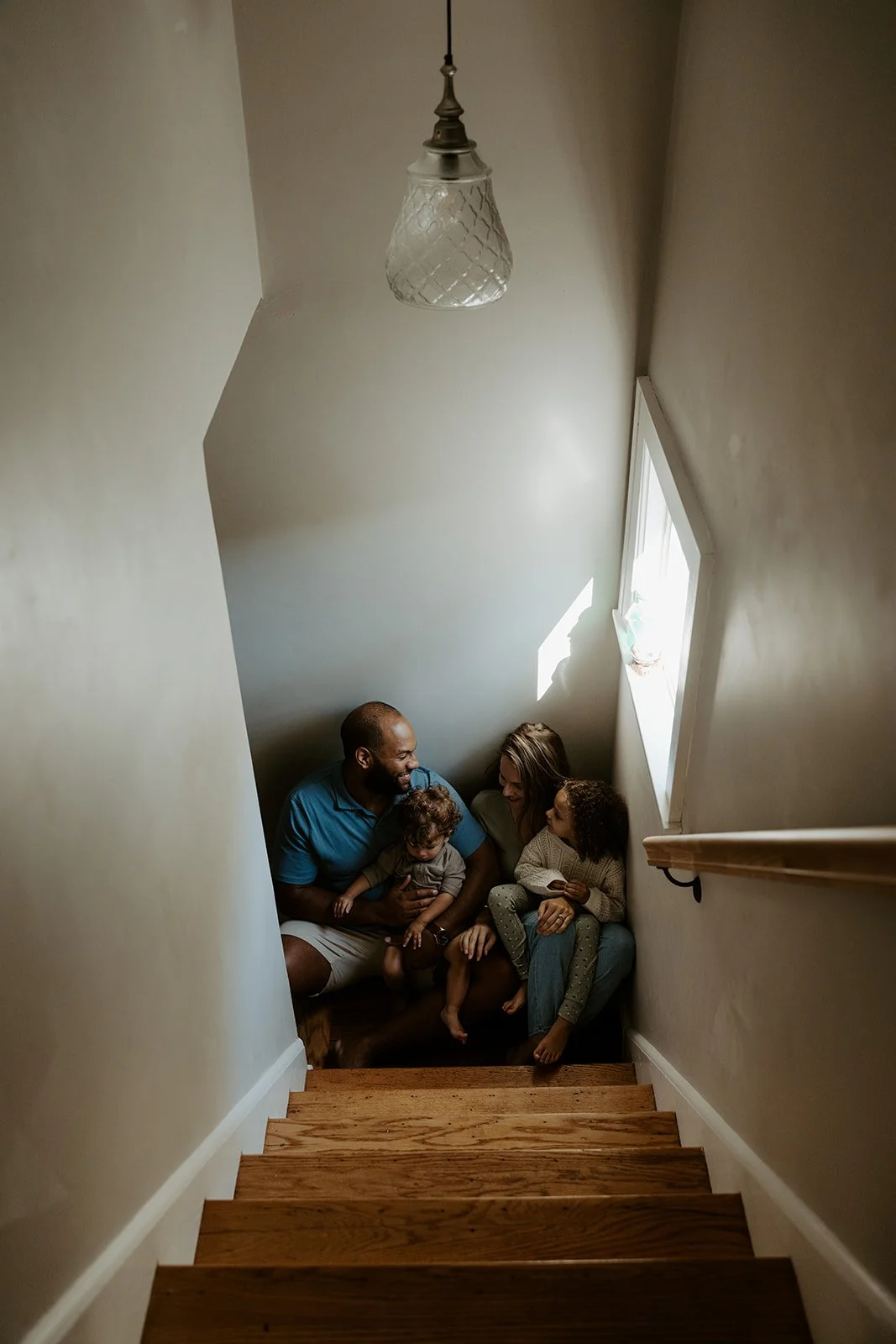 A family sitting on their steps for family photos at home