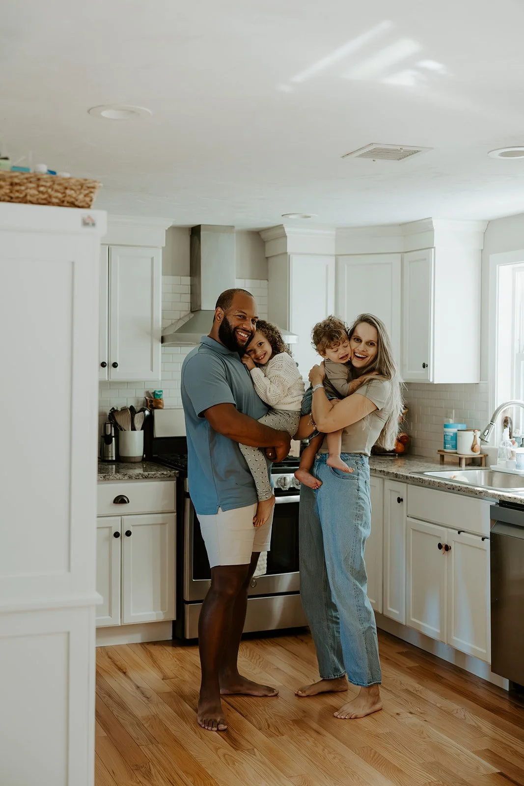 A family in the kitchen for family photos at home