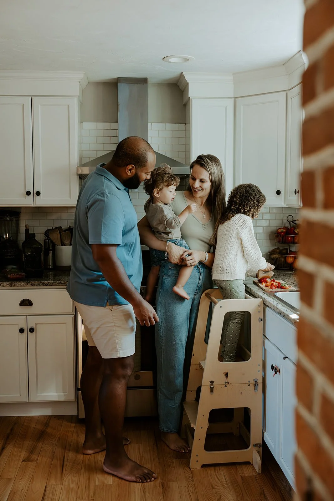 A family in their kitchen for family photos at home