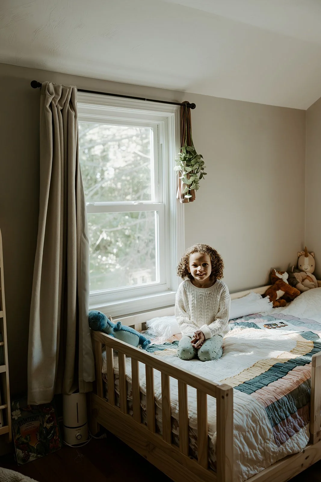 A little girl in her bedroom for family photos at home