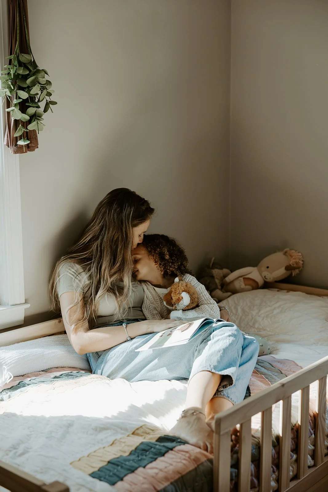 A little girl with her mom in her bedroom for family photos at home