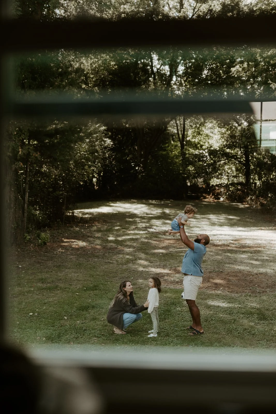 A family playing in their backyard during family photos at home