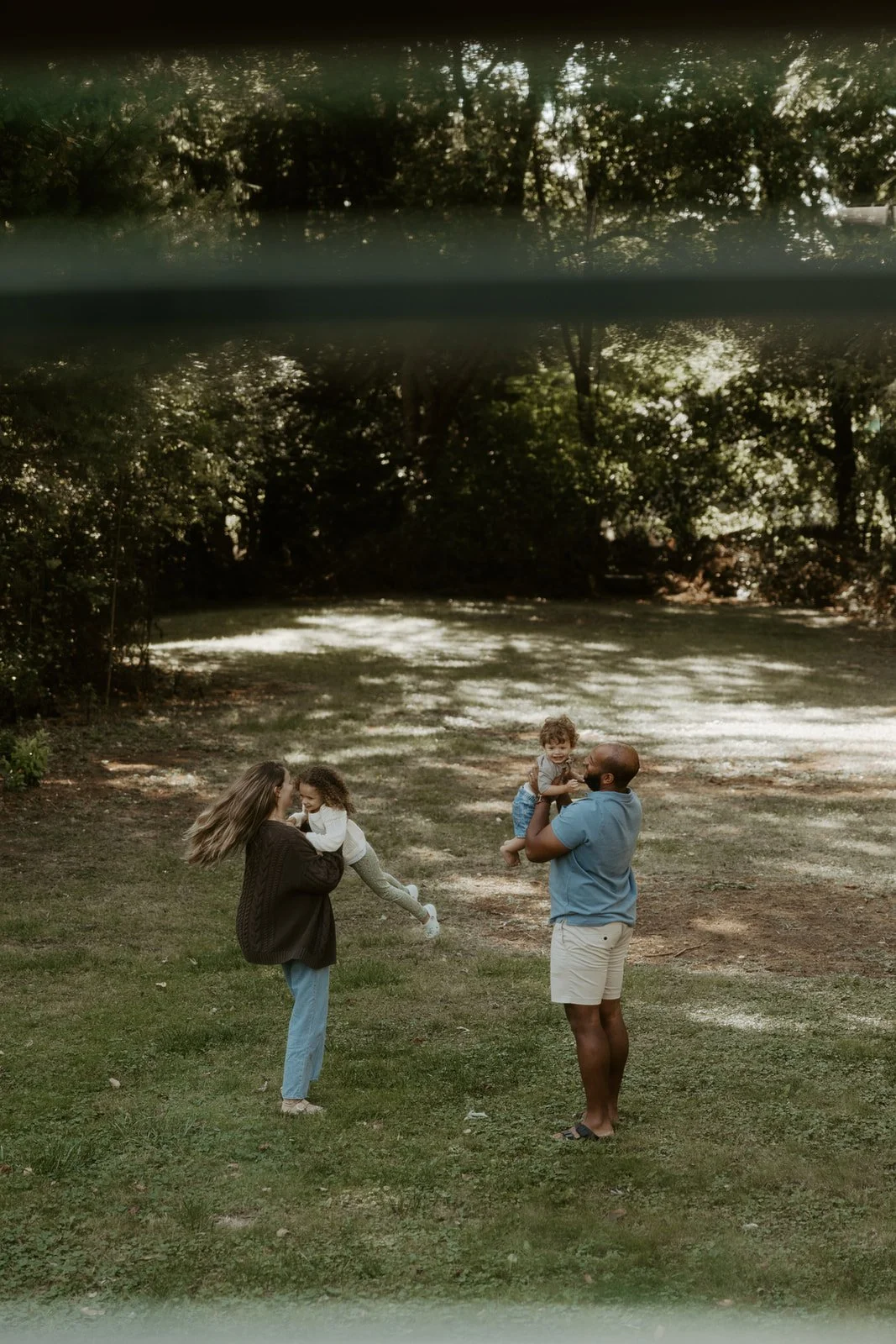 A family playing in their backyard during family photos at home