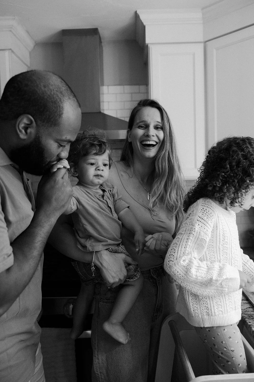 A family in the kitchen during at home family photos