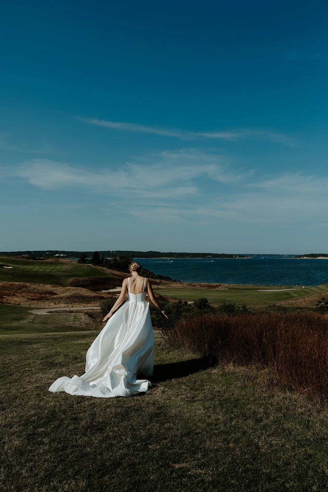 A bride walking towards the ocean at eastward ho! 