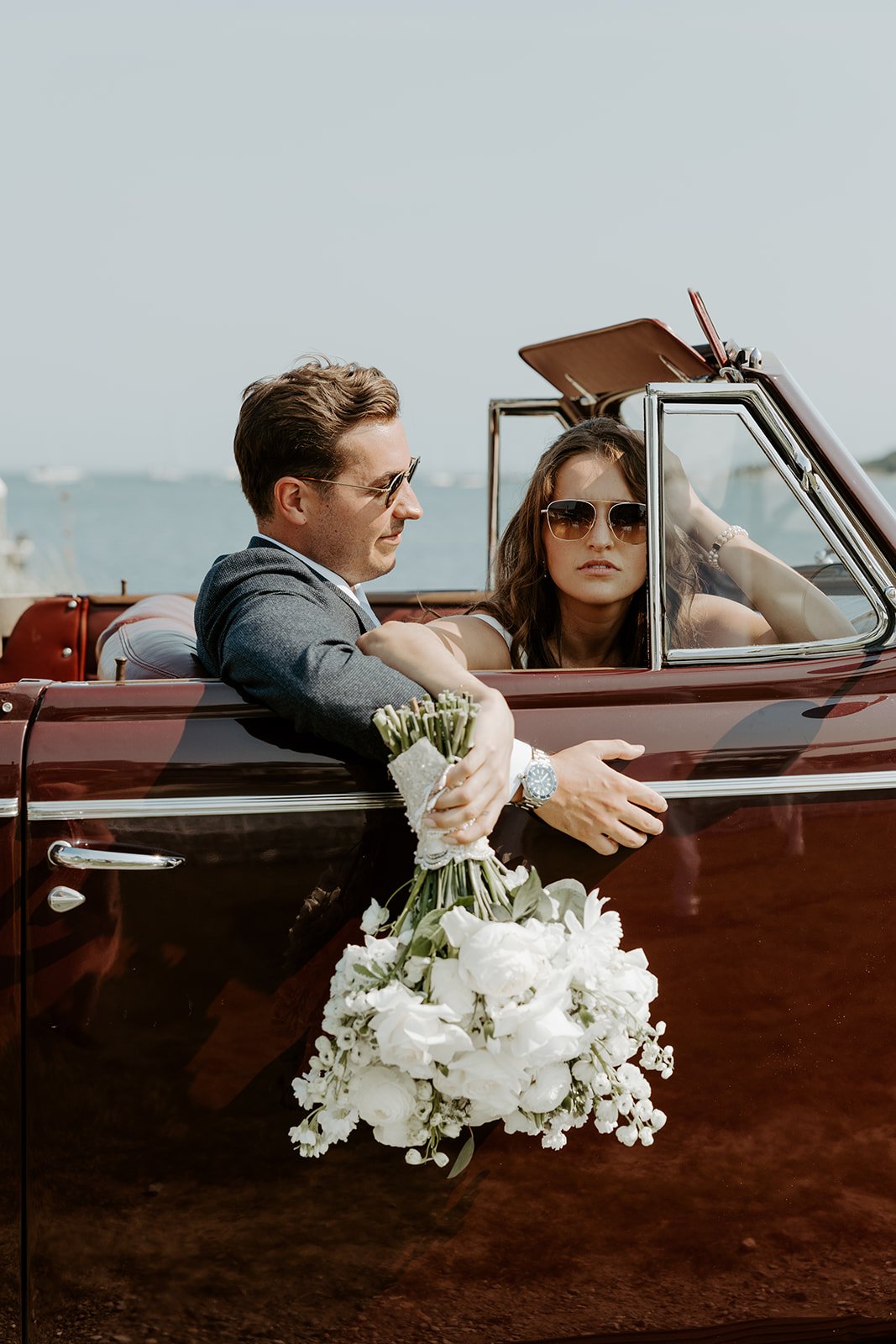  bride and groom in a vintage car