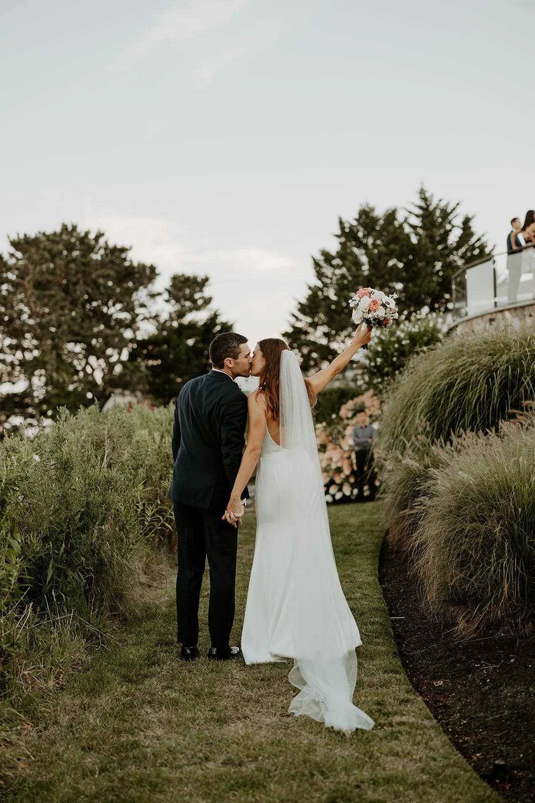 A bride and groom walking through wequassett resort